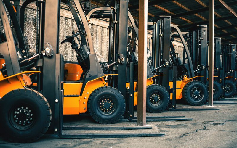 Background of a lot of forklifts, reliable heavy loader, truck. Heavy industrial equipment