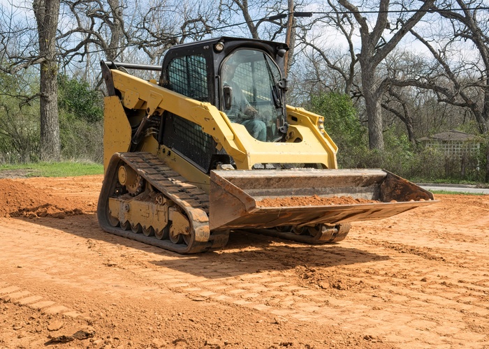 Skid Steer Carrying Dirt in Front Bucket