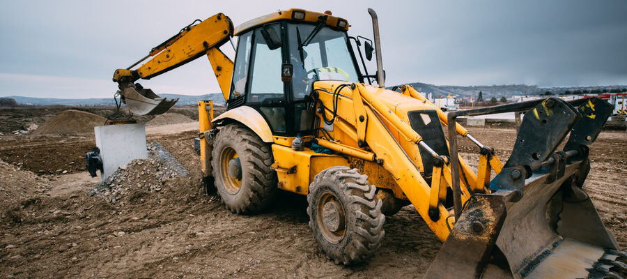 backhoe loader with excavator on construction site