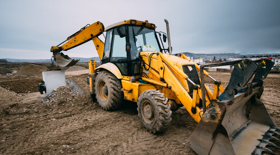 backhoe loader with excavator on construction site