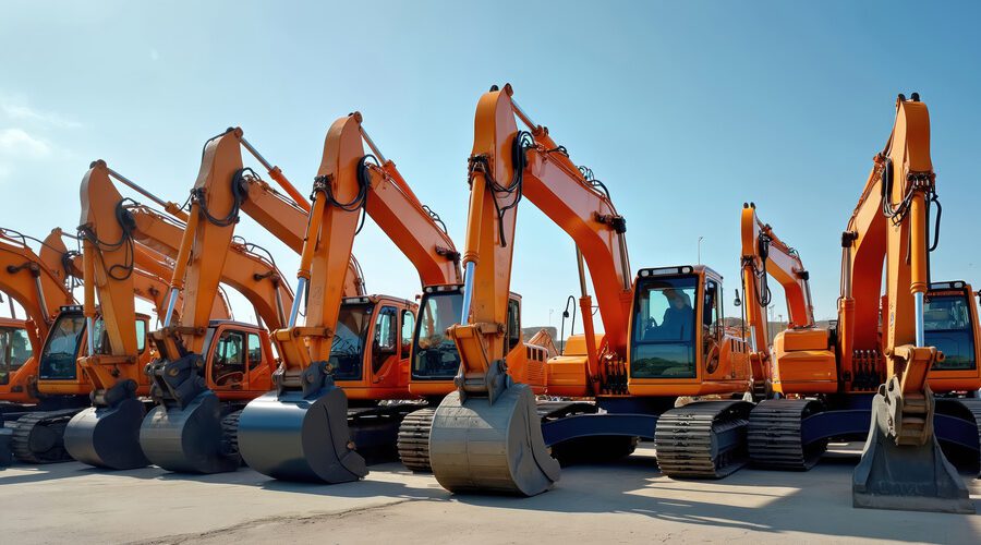 Row of excavators in parking lot