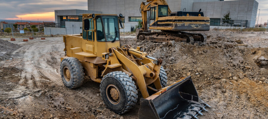 Two excavators at a construction site performing earthmoving